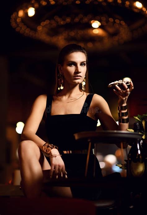 Beautiful Fashion Brunette Woman In Expensive Interior Restaurant Eat Oyster Waiting Stock Image