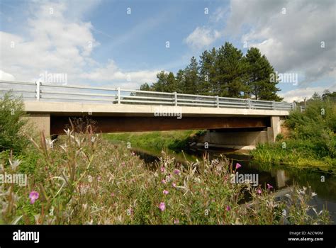 Newly Built Road Bridge Over A Stream In The Uk Countryside Stock Photo