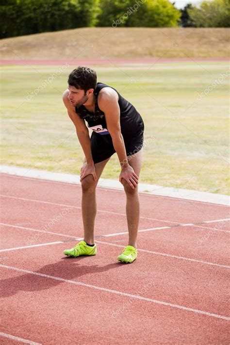 Tired Athlete On Running Track Stock Photo By ©wavebreakmedia 110791220