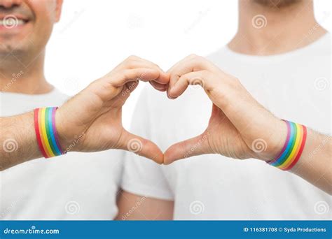 Gay Couple With Rainbow Wristbands And Hand Heart Stock Photo Image