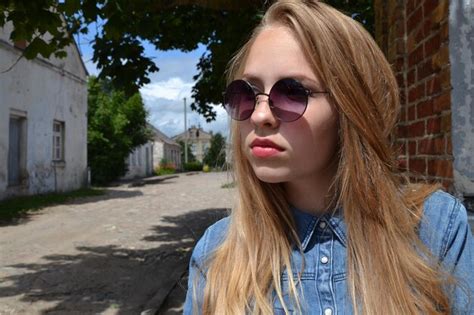 Premium Photo Woman Wearing Sunglasses Looking Away Outdoors