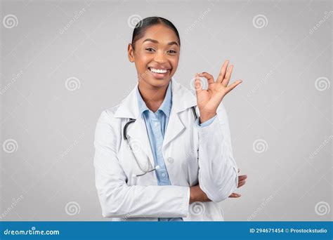 Glad Pretty Adult African American Woman Doctor In White Coat Make Ok