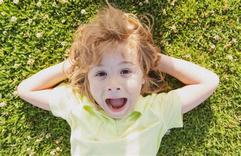 Funny Amazed Surprised Excited Child Lying On Grass Kids Head Fun