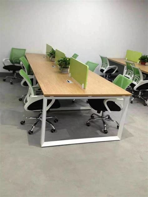 An Empty Conference Room With Green Chairs And Plants On The Table In