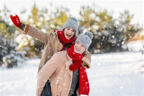 Cheerful Couple Enjoying Snowy Winter Day At Park Copy Space Stock