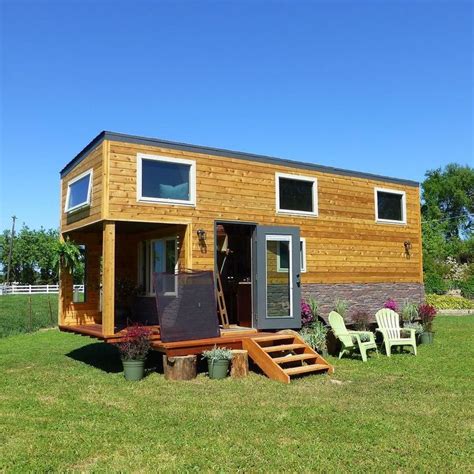 The Tiny House Is Made Out Of Wood And Has Stairs Leading Up To It S