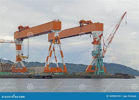 Huge Gantry Cranes And Cargo Container Ships Royalty Free Stock Photo