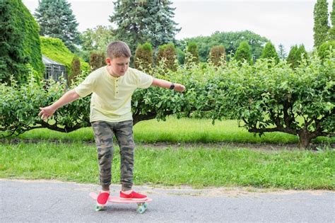 Premium Photo | Boy skateboarding in the park the child goes in for sports