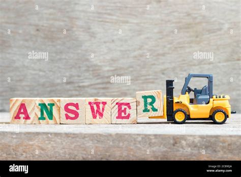 Toy Forklift Hold Letter Block R To Complete Word Answer On Wood