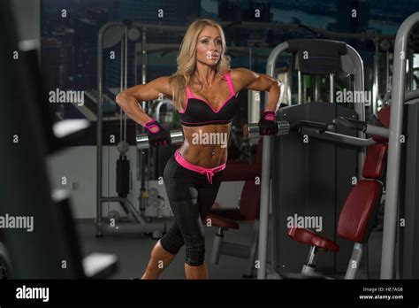 Mature Fitness Woman Working Out Back In Fitness Center Stock Photo Alamy
