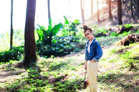 Premium Photo Portrait Of Woman Standing Against Trees In Forest