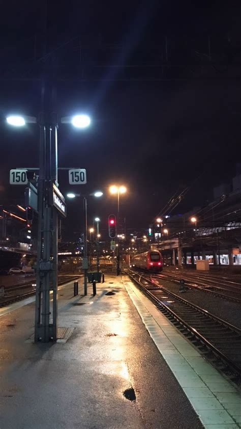 An Empty Train Station At Night With The Lights On And No One Is