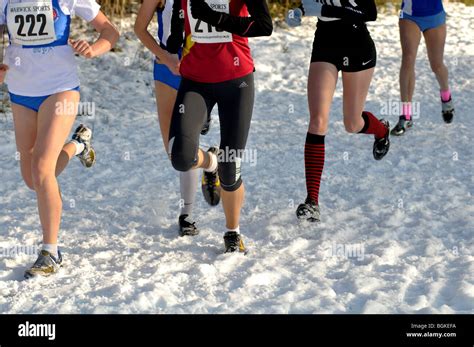 Teenage girls running in cross-country race in snow Stock Photo - Alamy