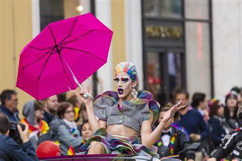 An Extravagant Drag Queen With A Pink Umbrella Attending The Gay Pride Parade Also Known As