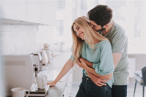 Beautiful Cheerful Couple Relaxing In Their Kitchen Stock Photo Image Of Blonde Home