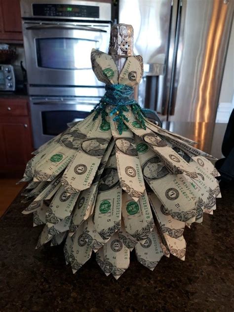 A Dress Made Out Of Dollar Bills Sitting On Top Of A Counter