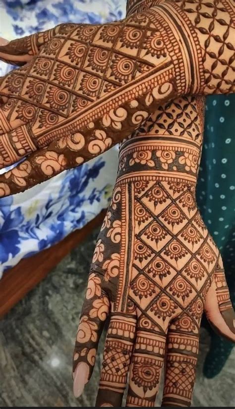 The Hands And Arms Of A Woman With Henna Tattoos