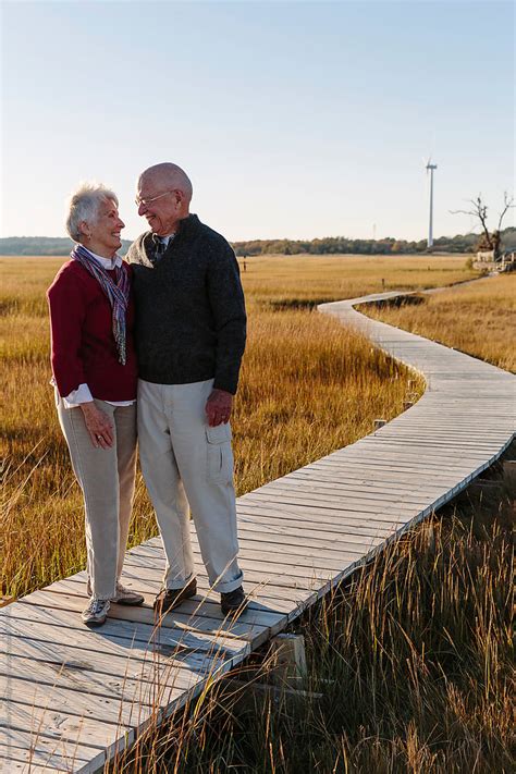 Senior Couple Smile Together On Autumn Walk By Stocksy Contributor