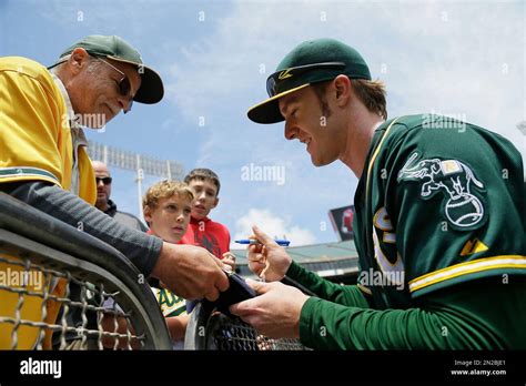 Oakland Athletics Left Fielder Mark Canha Signs Autographs Before Their