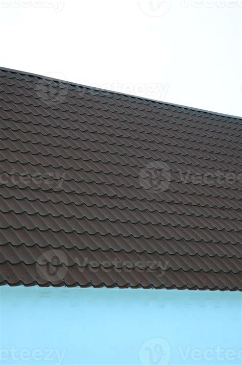 Brown metal roof tiles. Metal Roof Shingles - Roofing Construction 12837758 Stock Photo at Vecteezy