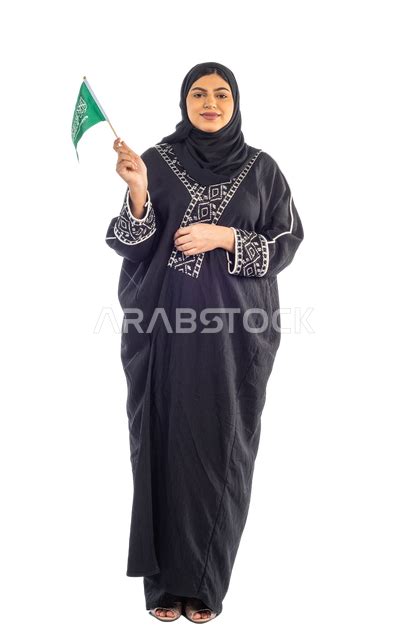 Portrait Of A Saudi Arabian Gulf Woman Holding The Flag Of The Kingdom