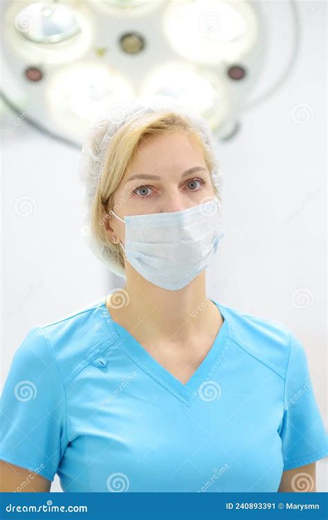 Portrait Of Female Surgeon Wearing In Medical Face Mask And Protective