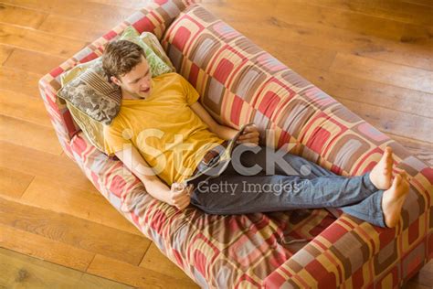 Young Man Reading Magazine On His Couch Stock Photo | Royalty-Free ...