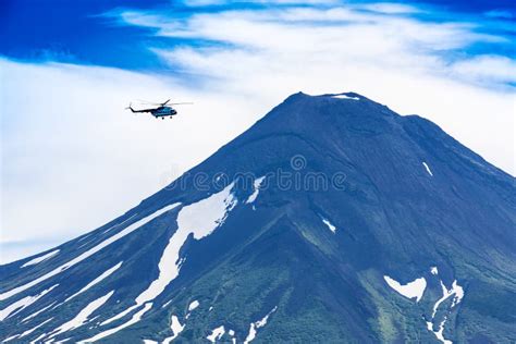 Helicopter Flying Over Ilyinsky Volcano And Kurile Lake Stock Photo