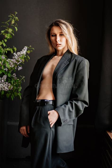 A Blonde Woman In A Black Jacket On A Naked Body In A Dark Room Stock Photo Image Of Beautiful