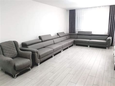 a living room filled with furniture next to a large window and hard ...
