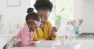 Excited African American Granddaughter And Grandmother Make Chemistry