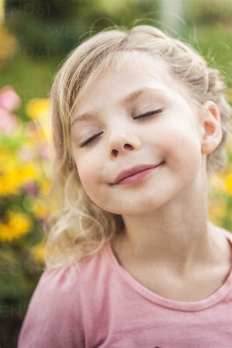 Close Up Portrait Of Young Girl With Eyes Closed Stock Photo