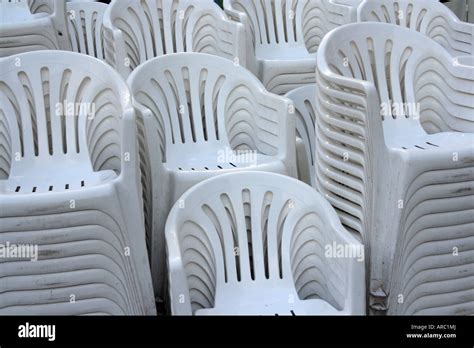 "White Plastic Stacking Chairs Stock Photo - Alamy