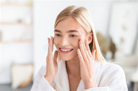 Blonde Lady Enjoys Freshness Of Skin Touching Face In Bathroom Stock Photo Image Of Care Lady