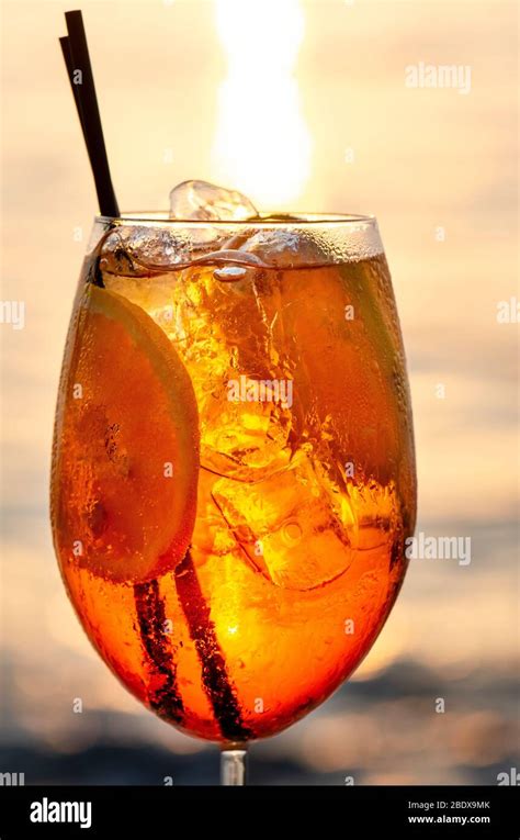 Aperol Spritz Cocktail on the beach with sunset Stock Photo - Alamy