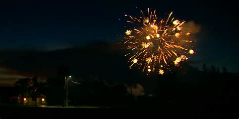 Colorful Fireworks Shoot Across the Sky Against a Gorgeous Backdrop of Cloud Lightning