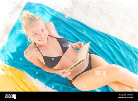 Happy Woman In Bikini Reading Book On Beach Stock Photo Alamy