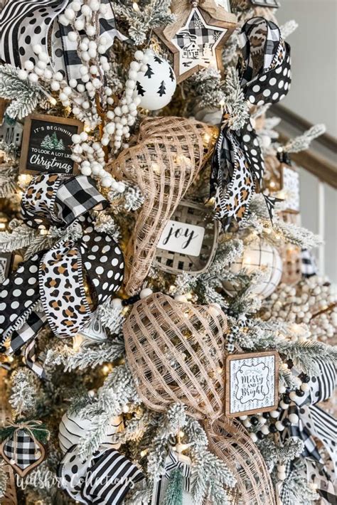 A Christmas Tree Decorated With Black And White Ribbon Ornaments And