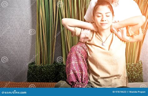 Thai Masseuse Doing Massage For Woman In Spa Salon Asian Beautiful Woman Getting Thai Herbal