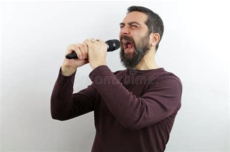 Screaming Strong Muscular Man Bodybuilder Stands With Naked Chest Shirtless Holding Up His