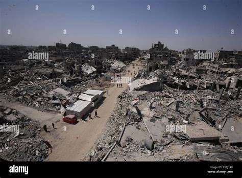 palestinians walk  rubble  houses    day  eid al