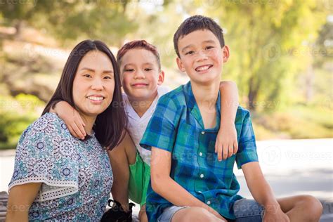 Outdoor Portrait Of Biracial Chinese And Caucasian Brothers And Their