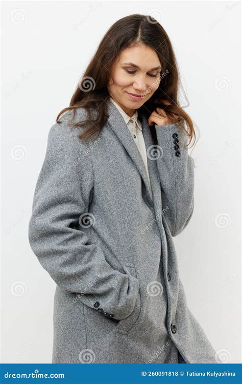 Vertical Portrait Of An Adult Woman With Long Dark Hair In A Warm