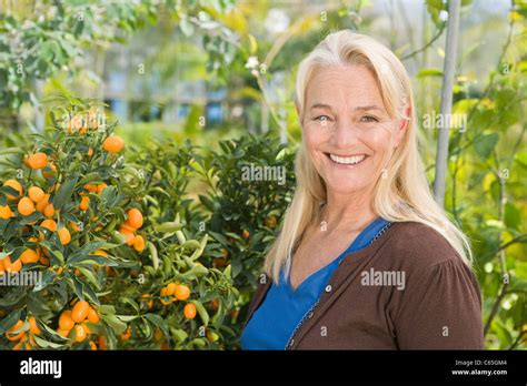 Mature Woman By Fruit Tree Stock Photo Alamy