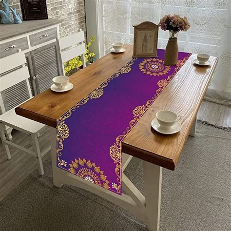 a purple table runner on top of a wooden table