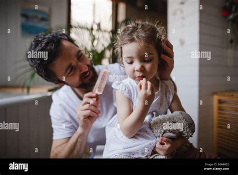 Mature Father With Small Daughter Indoors In Bathroom At Home Combing Hair Stock Photo Alamy