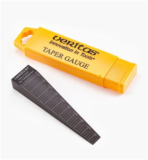 A Yellow Taper And Ruler Sitting Next To Each Other