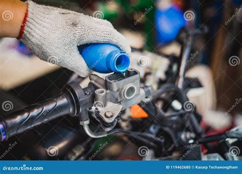 Mechanic Check And Add Brake Fluid On Motorcycle Brake Reservoir Stock