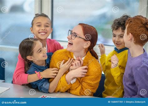 Happy And Joyful Pupils Hugging Their Favourite Teacher Stock Image Image Of Eyeglasses