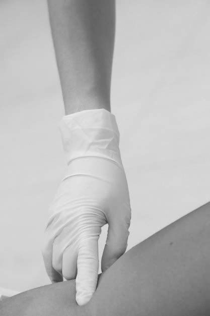 Premium Photo Cropped Hand Of Doctor Examining Patient